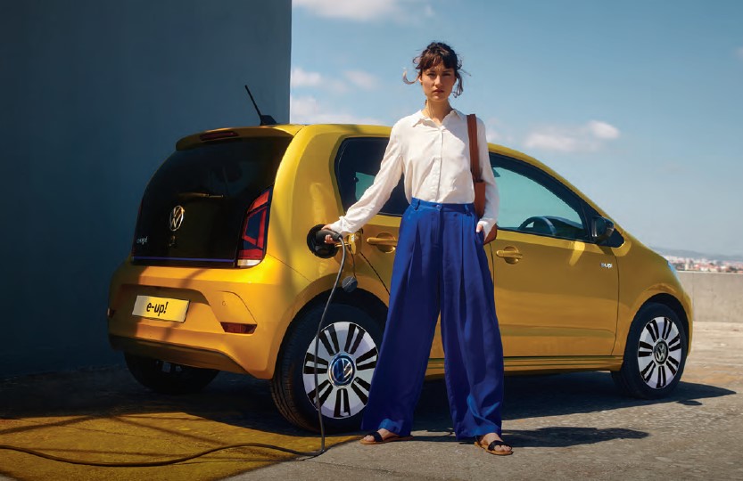 Women charging volkswagen e-up